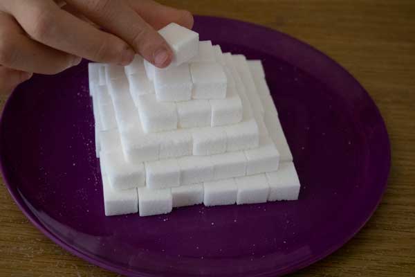 placing the last sugar cube on top of a square pyramid