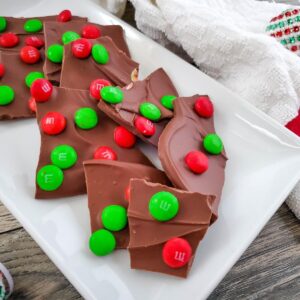 pieces of christmas chocolate bark dotted with red and green M&Ms