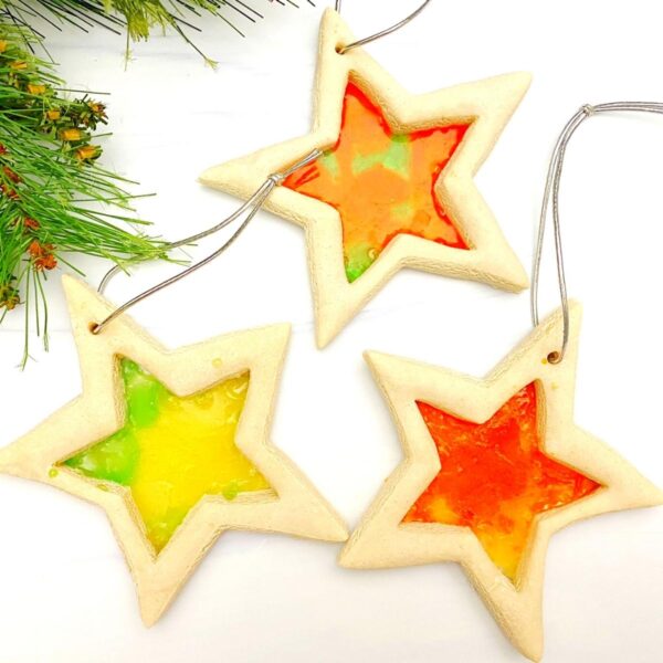 3 beautiful salt dough stained glass star ornaments with ribbon ready to hang on the Christmas Tree
