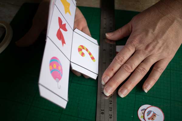 scoring and folding the net of a christmas dice for a printable game for preschool