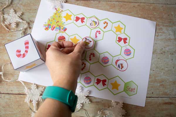 moving places on the christmas printable game as playing with preschoolers