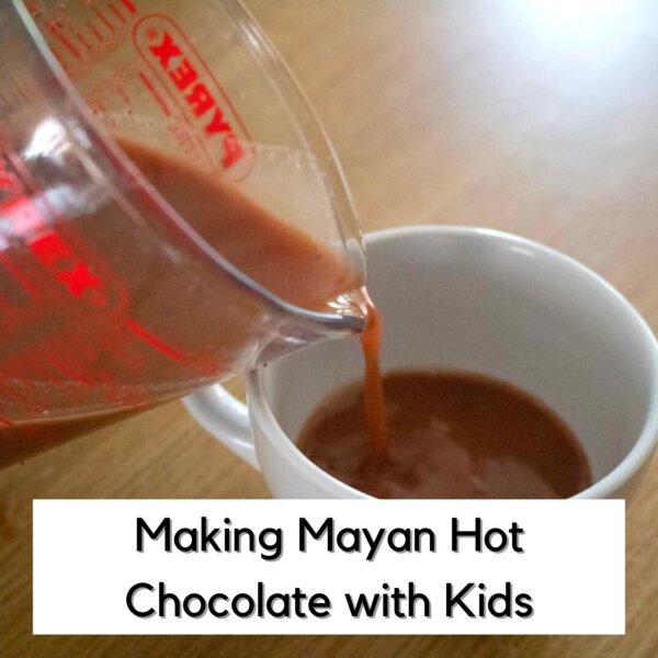 pouring Mayan Xocolatl from a jug into a cup to taste as part of a history unit on Mayan Civilisation