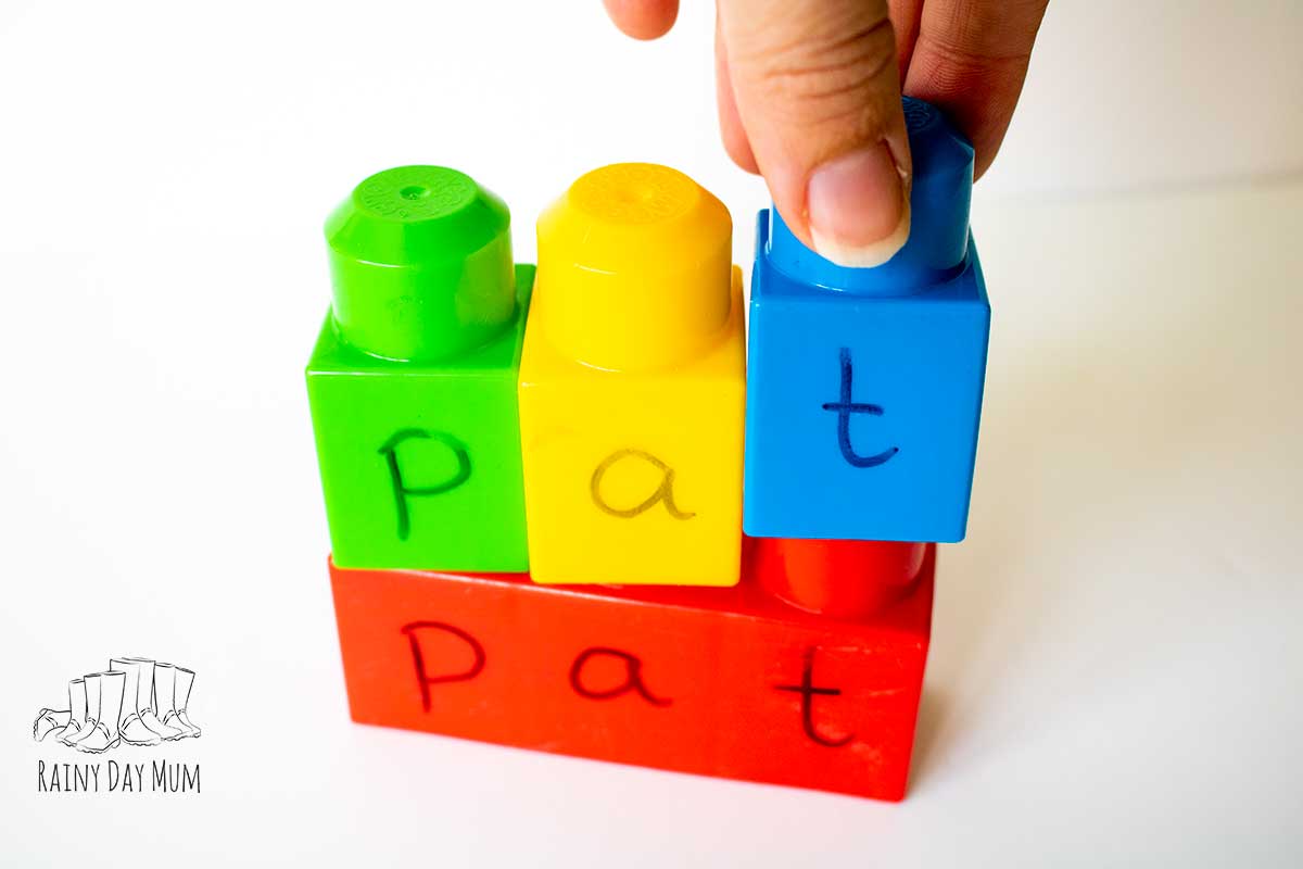 A hand putting the t on the word pat matching the word on the bottom 3 block.