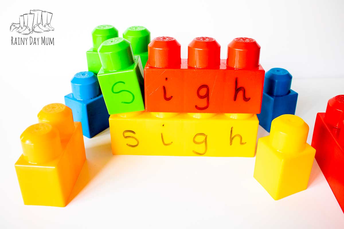 Building the word sigh with blocks. There is a 4 block on the base with the word sigh on and about it a single s block and the trigraph igh over the igh in sigh.