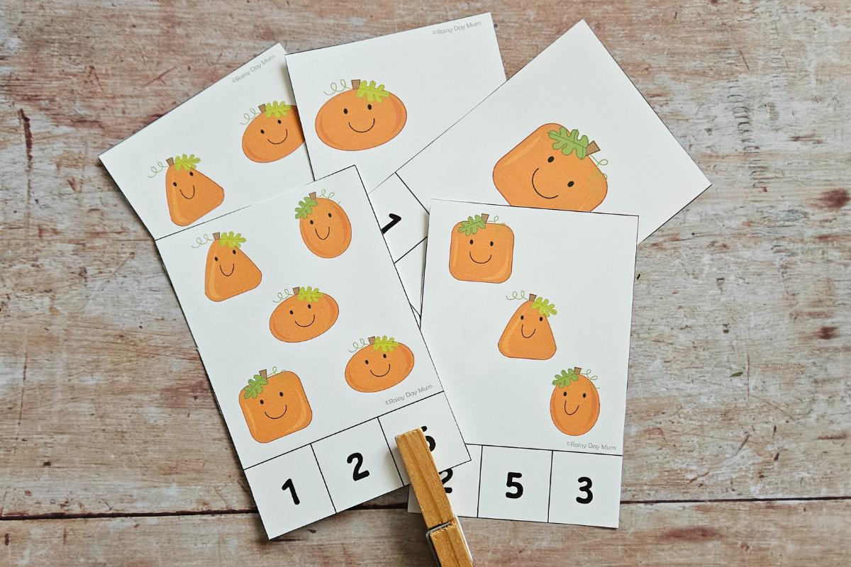 Clipping the correct number on a set of printable jack-o-lantern count and clip cards for toddlers and preschoolers.